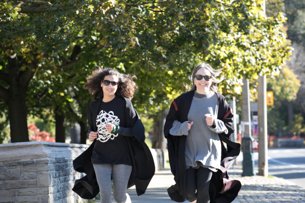2 Journalism fellows running in their gowns