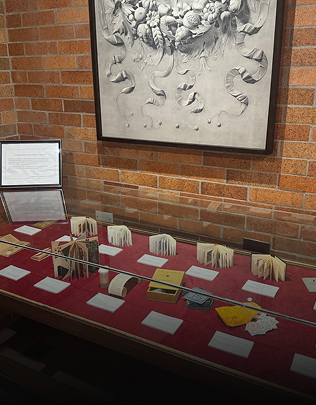 Artifacts laid out on a table for an exhibit inside the Robertson Davies Library