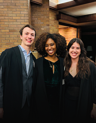 Students at Massey College stand together smiling